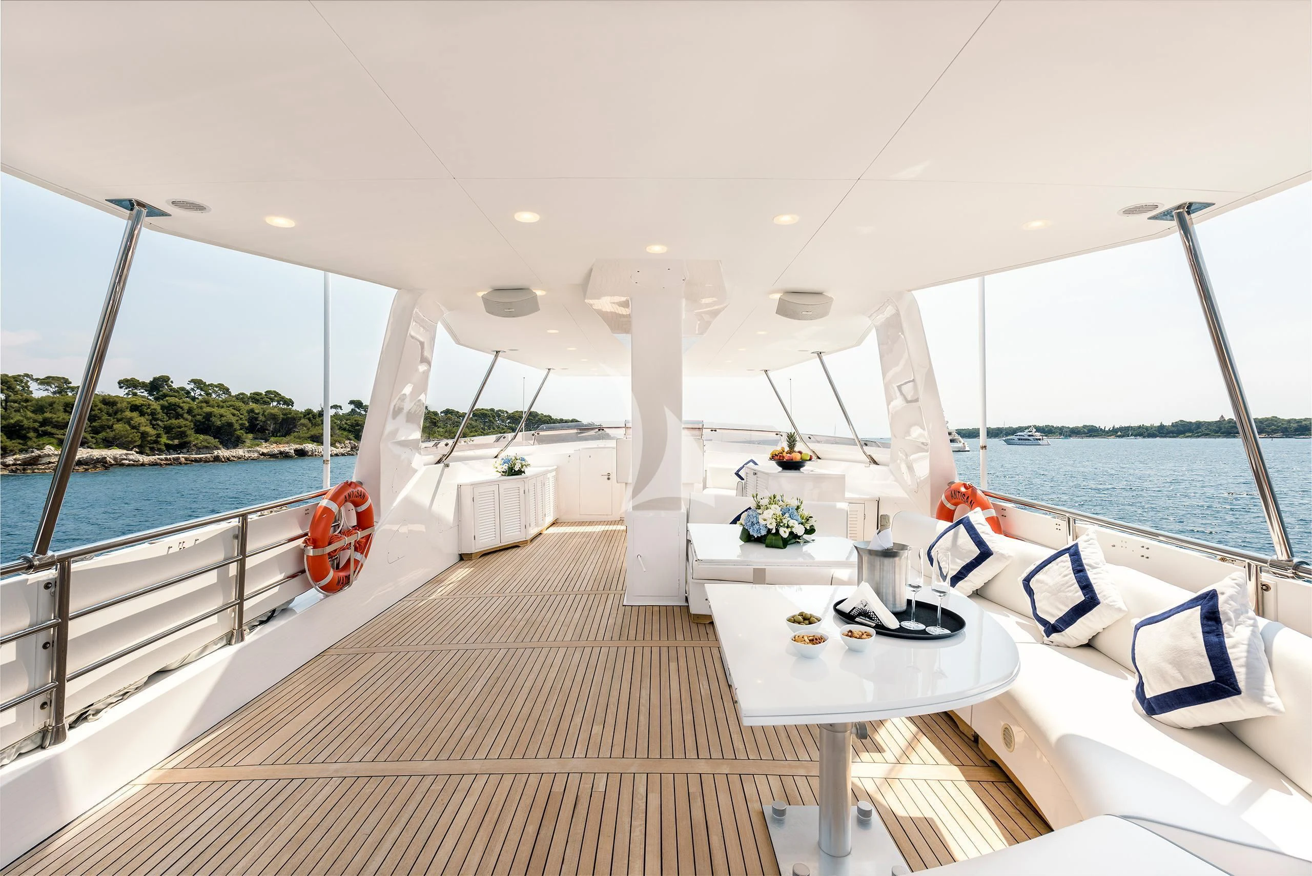 a room with a large deck and a view of the water aboard ANTISAN Yacht for Charter
