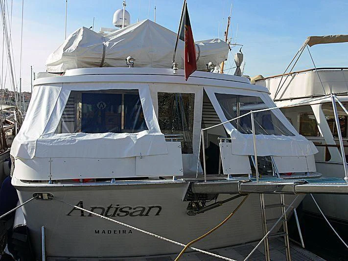 a white boat with a red and white stripe aboard ANTISAN Yacht for Charter