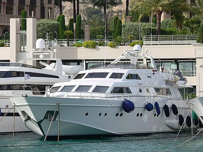 a white yacht in a harbor aboard ANTISAN Yacht for Charter