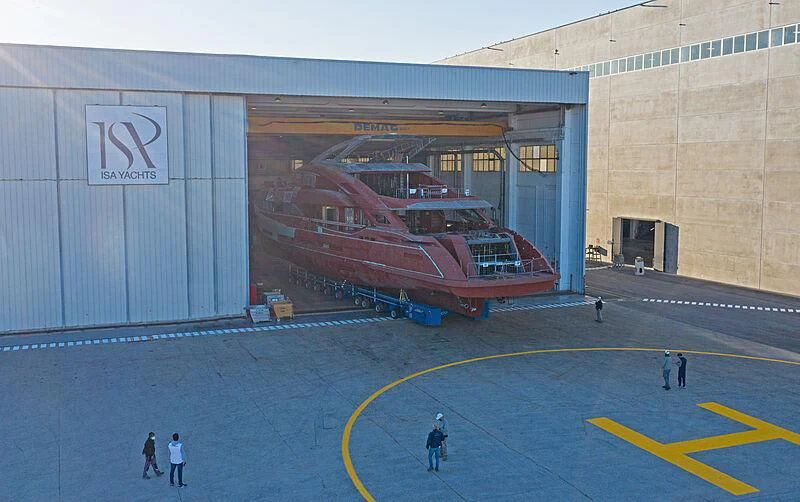 a group of people in a large building with a large red and blue track in front of it aboard ARIA SF Yacht for Sale