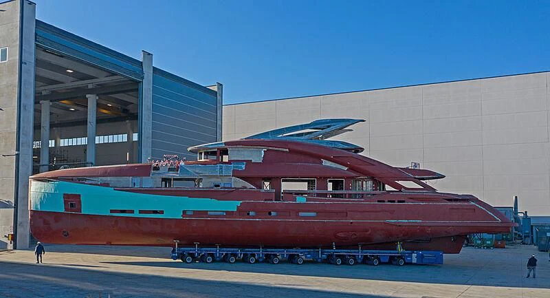 a large red train in front of a building aboard ARIA SF Yacht for Sale
