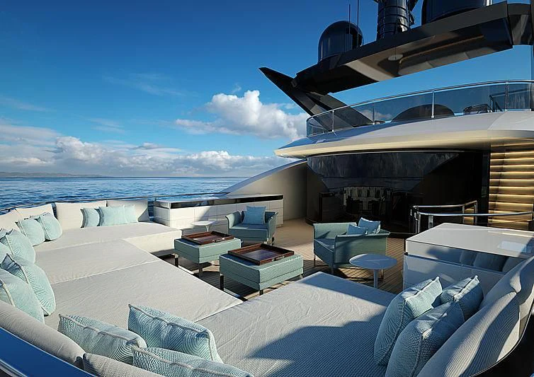 a large lounge area with a large body of water and a large boat in the background aboard ARIA SF Yacht for Sale