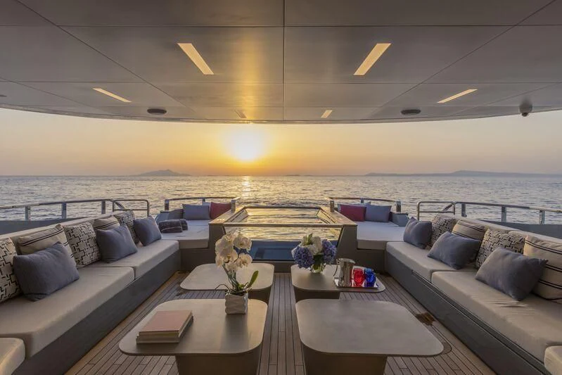a room with a couch and a table with a couch and a pool aboard ARIA SF Yacht for Sale