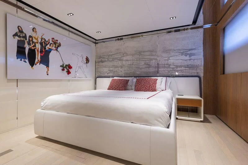 a room with a bed and a painting on the wall aboard ARIA SF Yacht for Sale