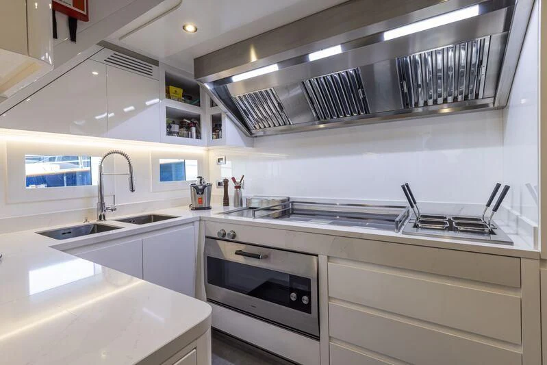 a kitchen with a steel stove aboard ARIA SF Yacht for Sale