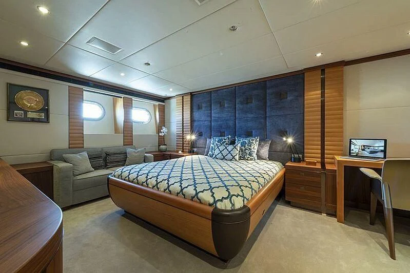 a bedroom with a bed and a couch aboard SPACE Y Yacht for Sale