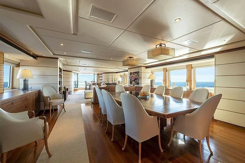 a large room with tables and chairs aboard SPACE Y Yacht for Sale