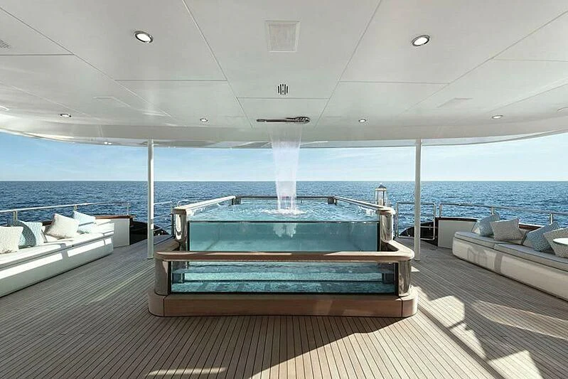 a deck with a pool and a view of the ocean aboard SPACE Y Yacht for Sale
