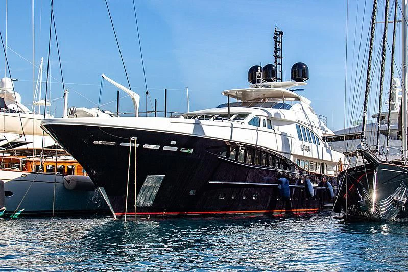 a large boat docked at a pier aboard SPACE Y Yacht for Sale
