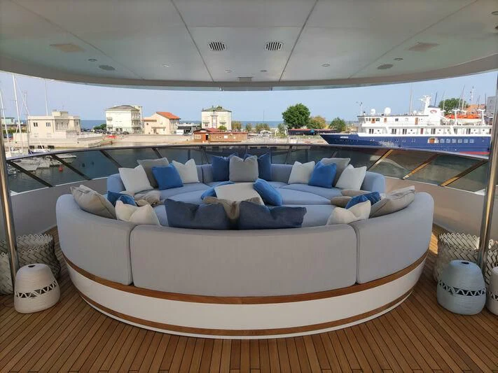 a large blue couch with pillows on it aboard SPACE Y Yacht for Sale