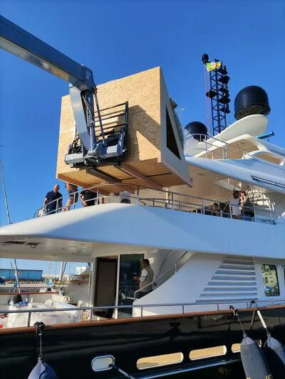 a building with a group of people on the roof aboard SPACE Y Yacht for Sale