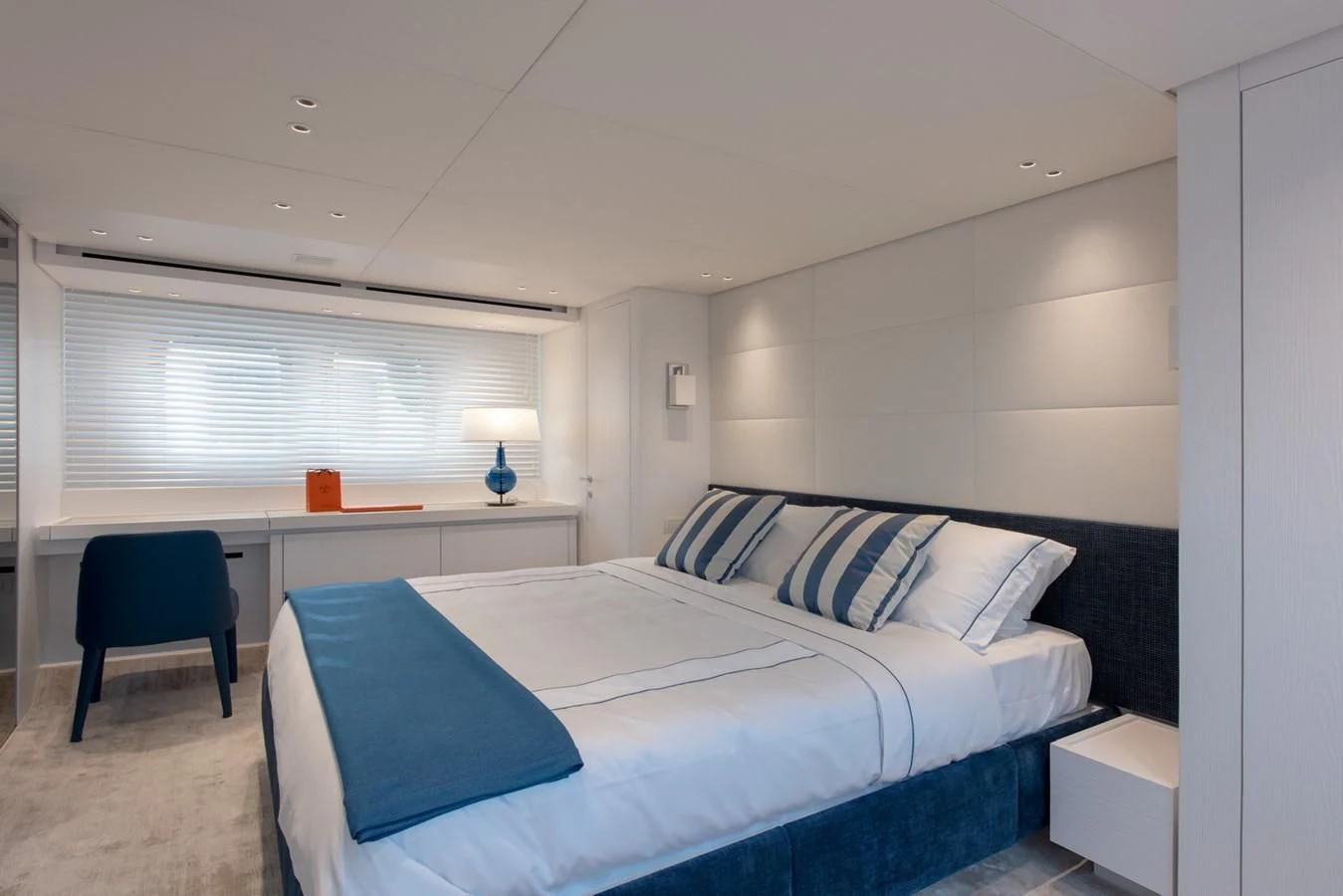 a bedroom with a bed and desk aboard VICKY Yacht for Sale