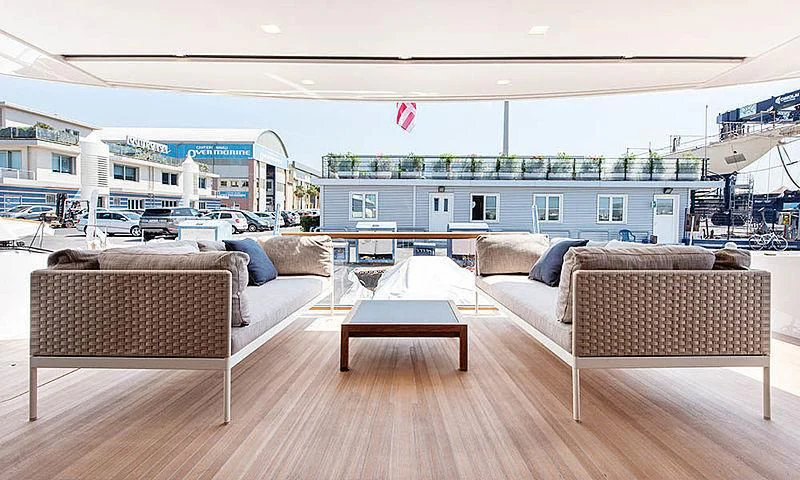 a couple of couches in a room with a table and chairs aboard VICKY Yacht for Sale