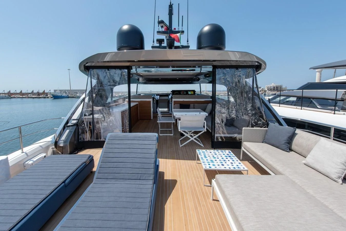 a deck with a table and chairs on it aboard VICKY Yacht for Sale