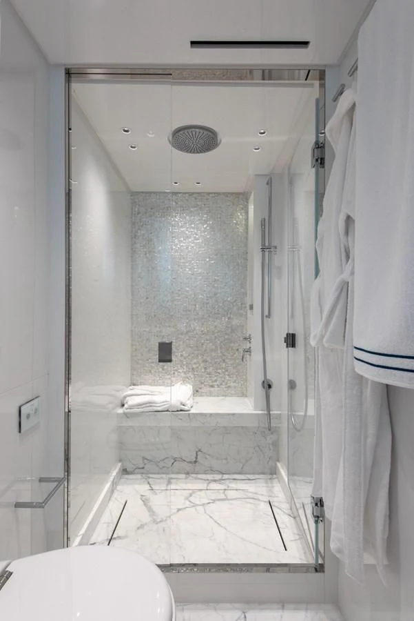 a bathroom with a glass shower aboard VICKY Yacht for Sale