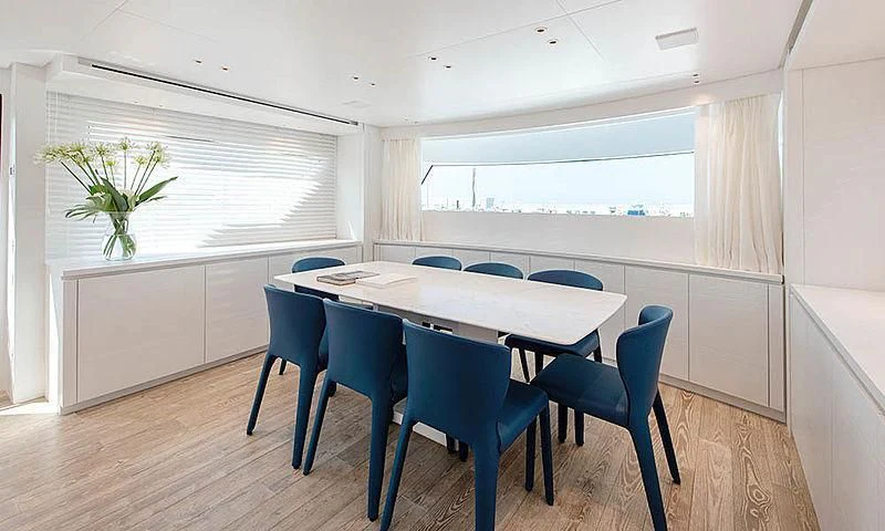 a table and chairs in a room aboard VICKY Yacht for Sale