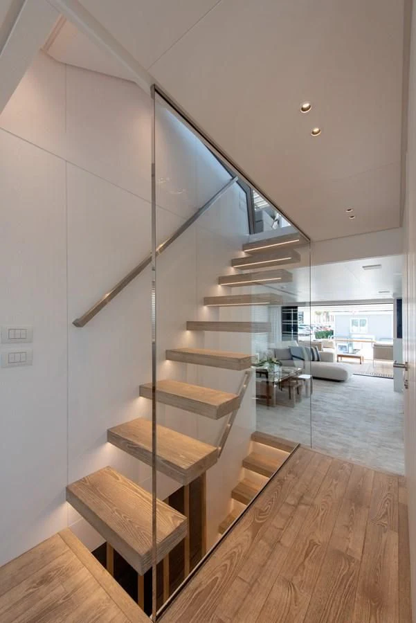 a staircase with a glass window aboard VICKY Yacht for Sale