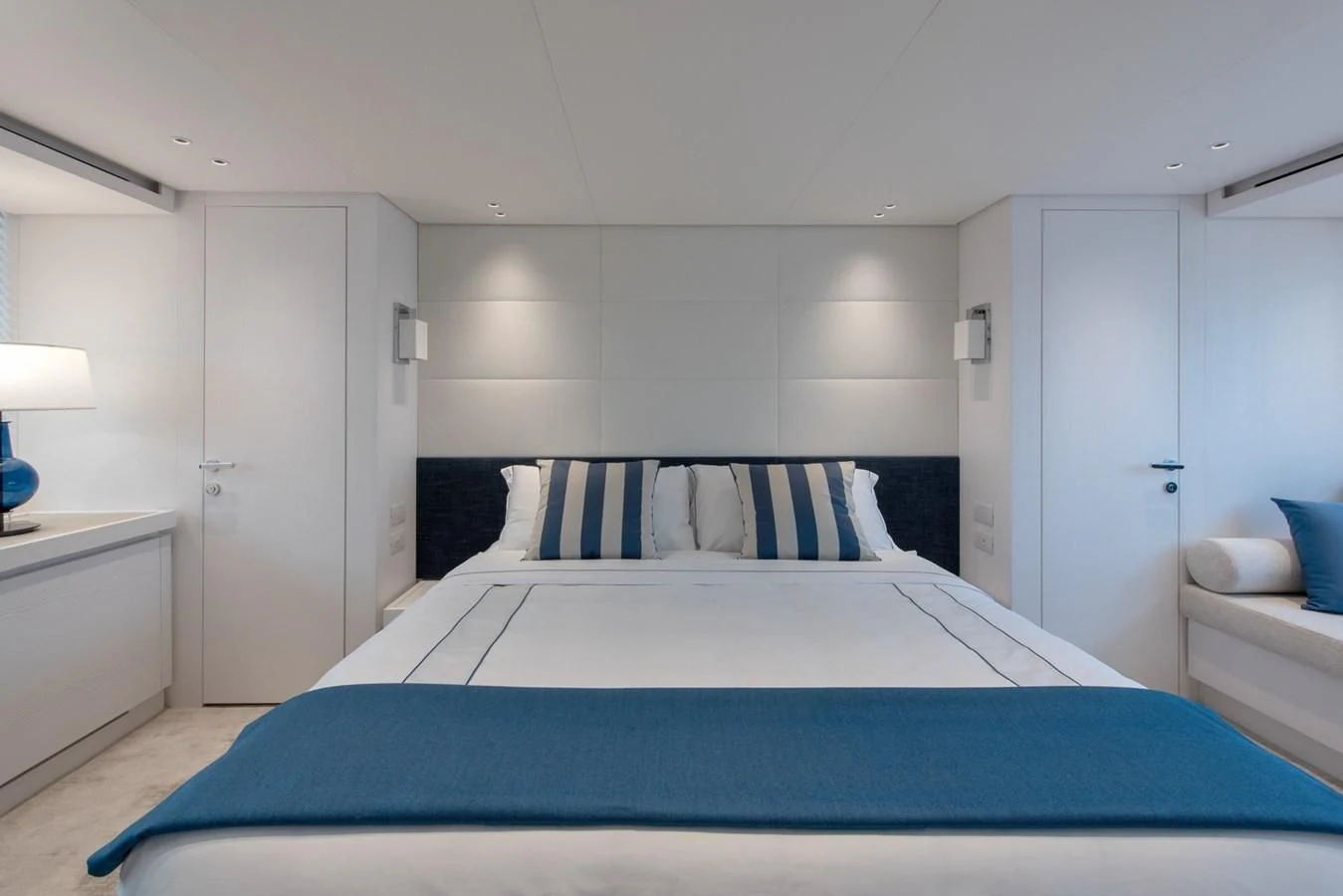 a bedroom with a blue bed aboard VICKY Yacht for Sale