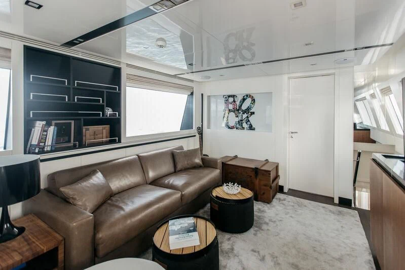 a living room with a couch and a book shelf aboard LEMANJA Yacht for Sale