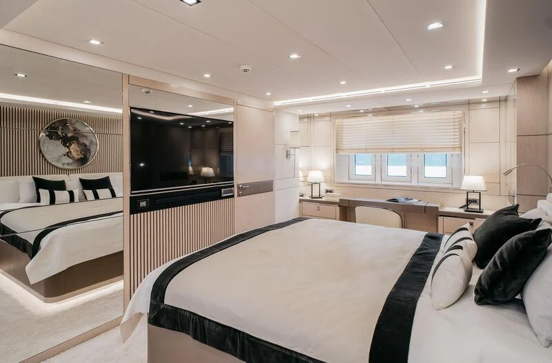 a bedroom with a bed and a mirror aboard LEMANJA Yacht for Sale