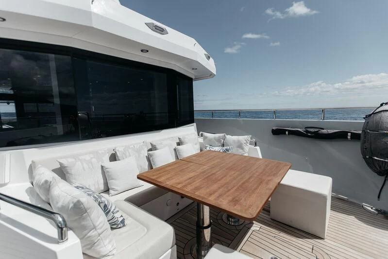 a table and chairs on a deck aboard LEMANJA Yacht for Sale
