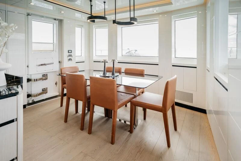 a kitchen with a dining table aboard LEMANJA Yacht for Sale