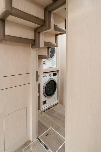 a white washing machine in a room aboard LEMANJA Yacht for Sale