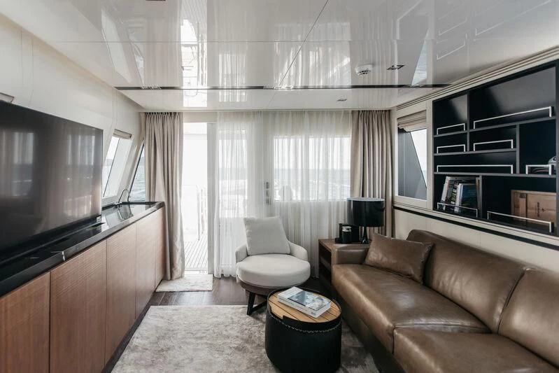 a living room with a couch and a tv aboard LEMANJA Yacht for Sale