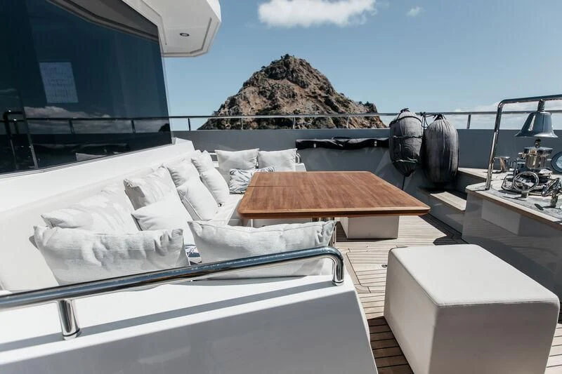 a room with a bed and a table with white sheets aboard LEMANJA Yacht for Sale