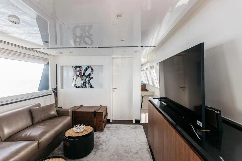 a living room with a couch and a fireplace aboard LEMANJA Yacht for Sale