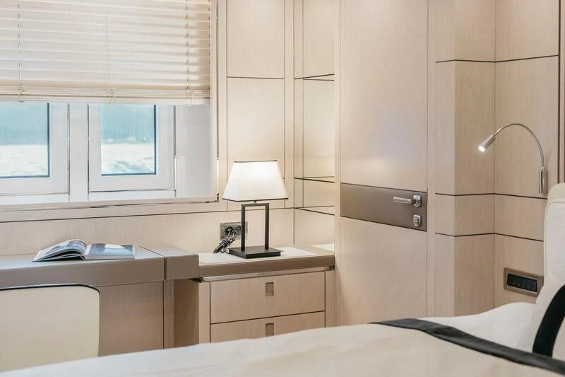 a room with a bed and a desk aboard LEMANJA Yacht for Sale