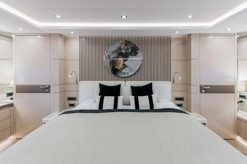 a large bed with a large round clock above it aboard LEMANJA Yacht for Sale