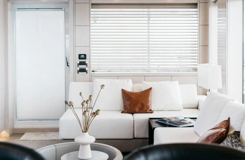 a living room with white furniture aboard LEMANJA Yacht for Sale