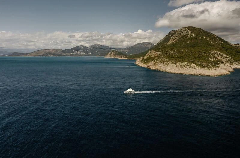 a body of water with a mountain in the distance aboard LEMANJA Yacht for Sale