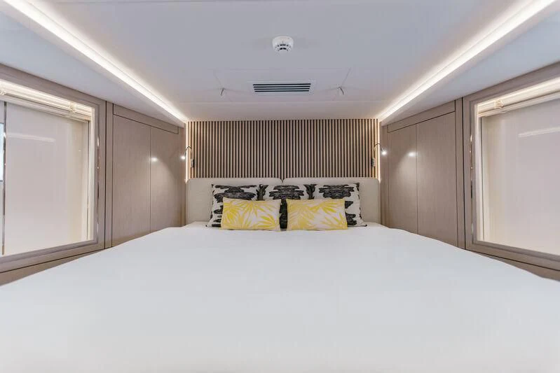 a bed with white sheets and pillows aboard LEMANJA Yacht for Sale