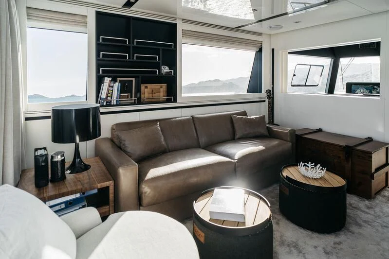 a living room with a leather couch aboard LEMANJA Yacht for Sale