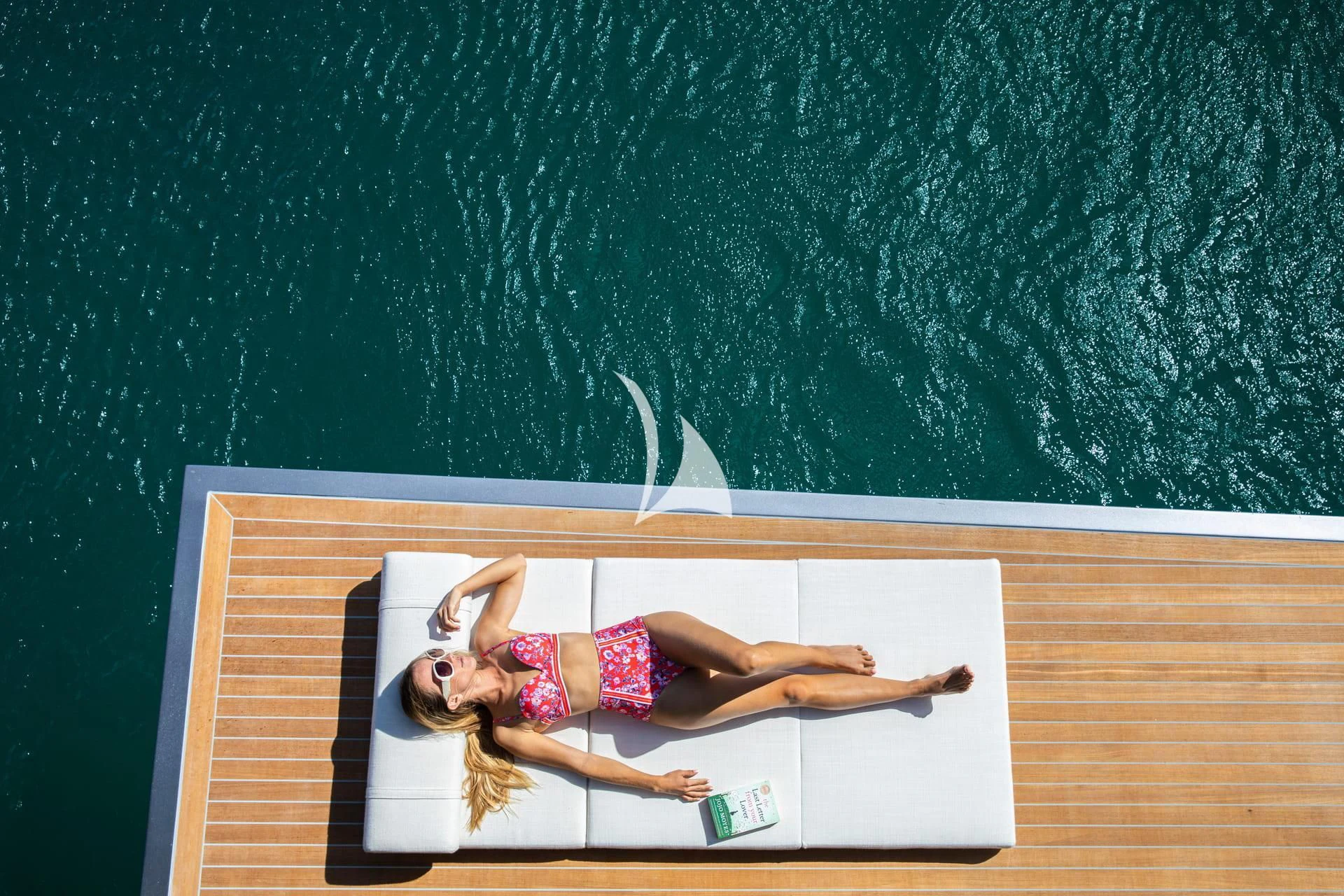 a girl lying on a chalkboard aboard WHY 200 Yacht for Sale