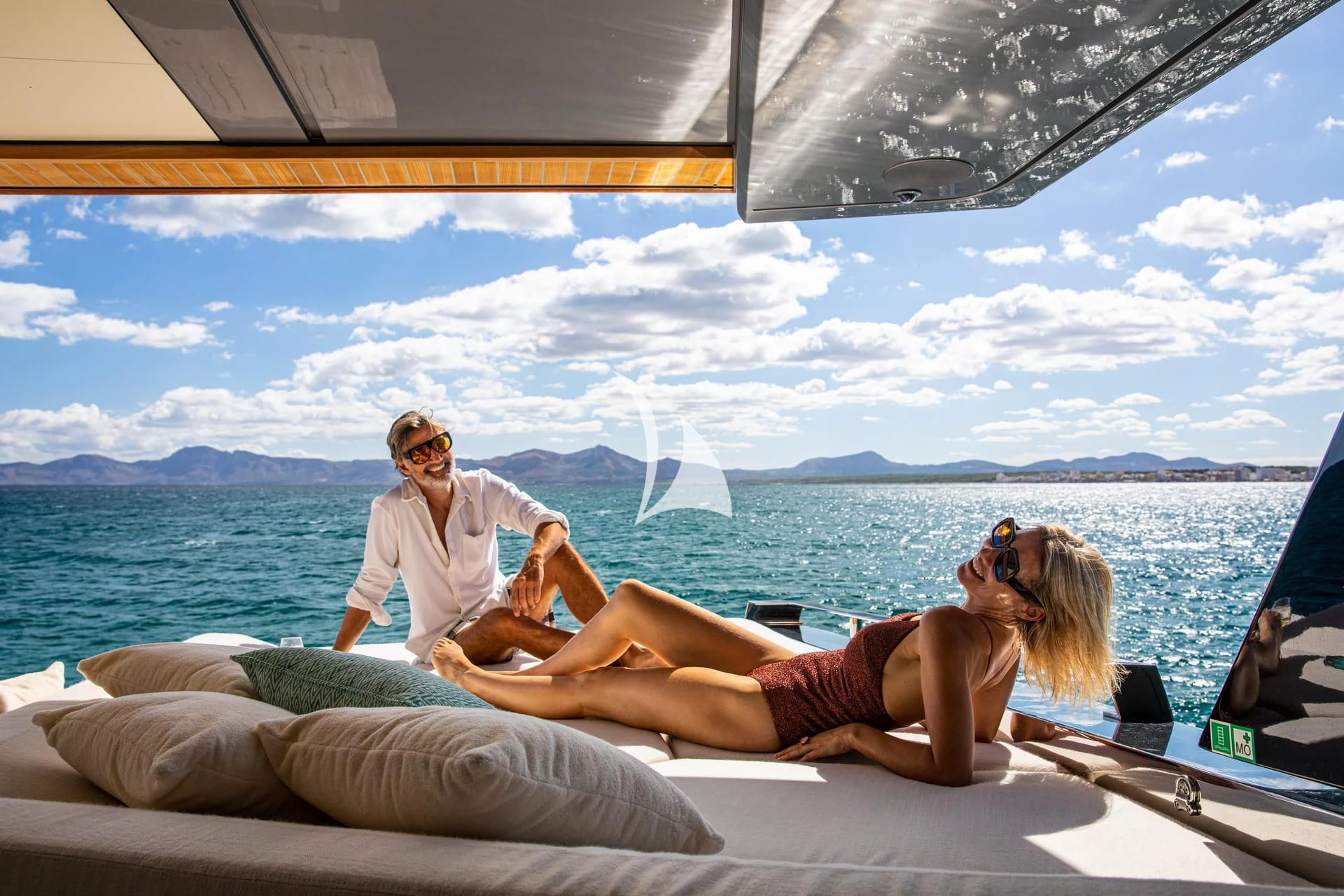 a man and woman sitting on a boat aboard WHY 200 Yacht for Sale