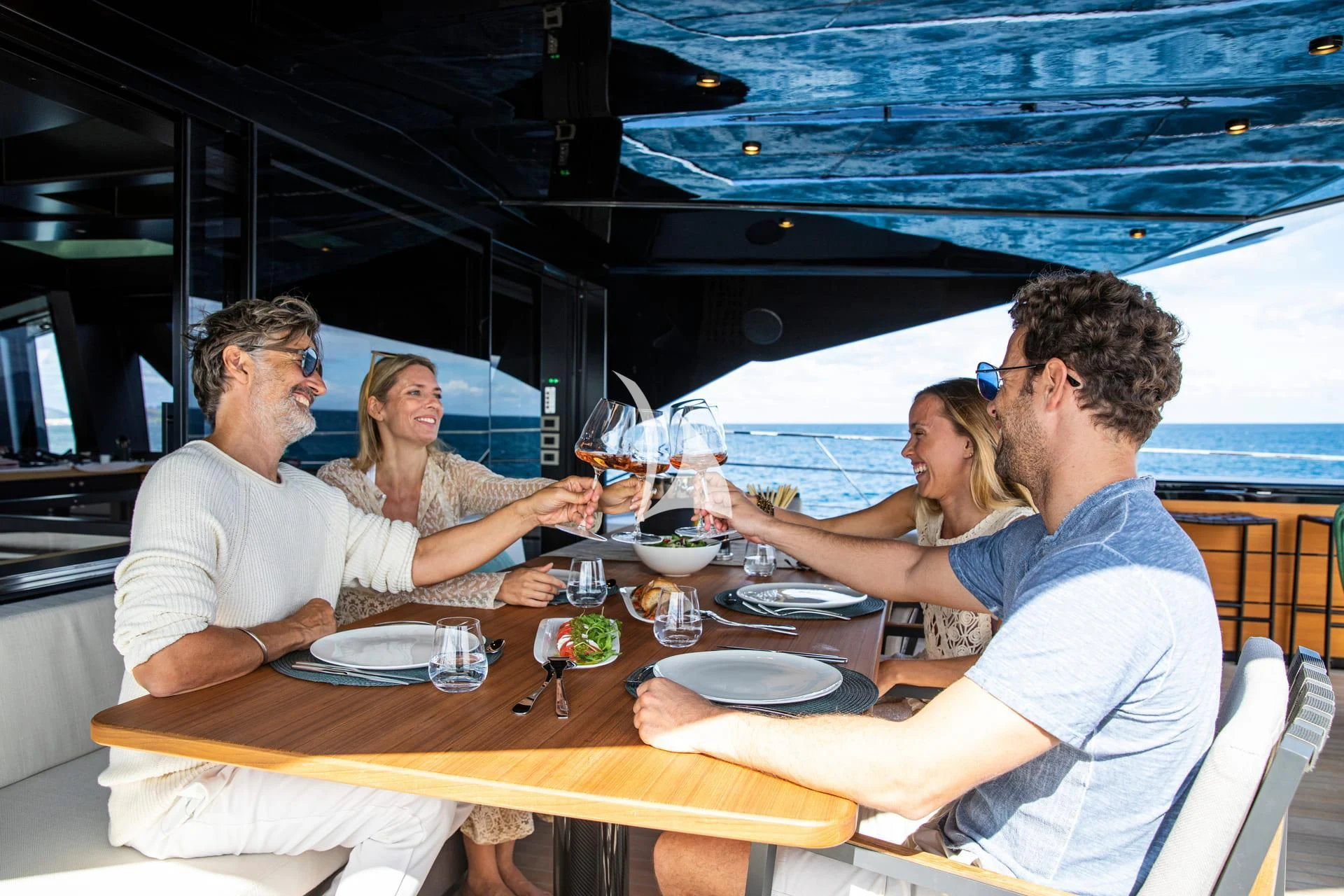 a group of people sitting around a table aboard WHY 200 Yacht for Sale