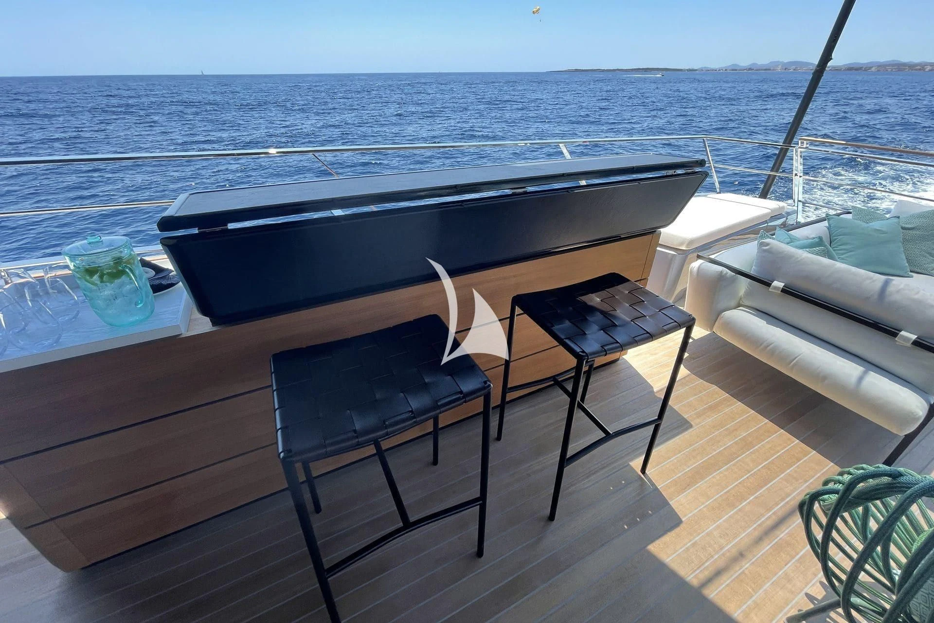 a table and chairs on a deck overlooking the ocean aboard WHY 200 Yacht for Sale
