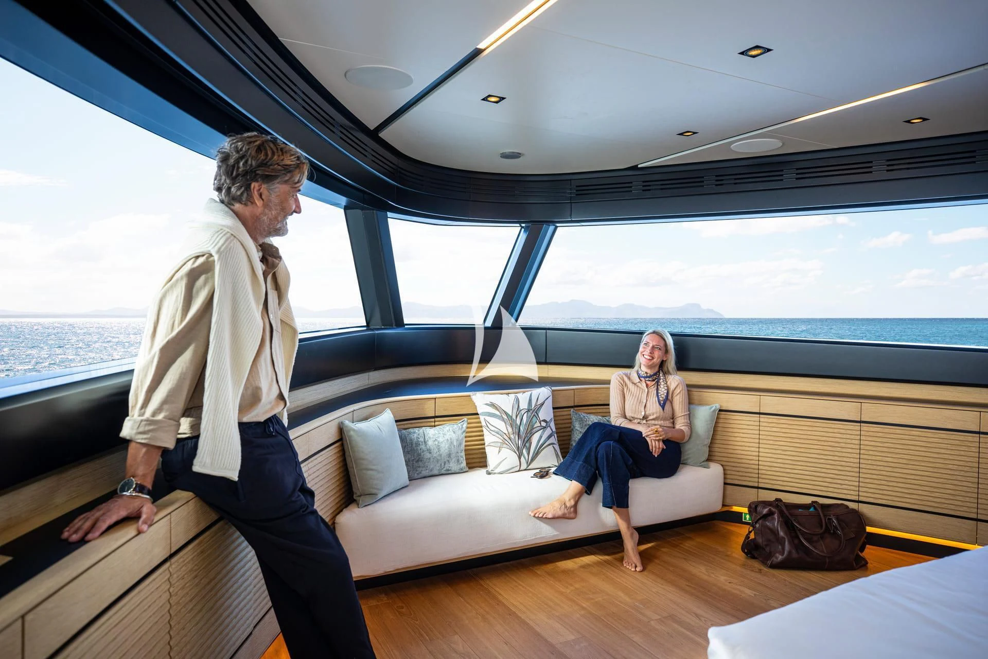 a man and a woman sitting on a couch in a boat aboard WHY 200 Yacht for Sale