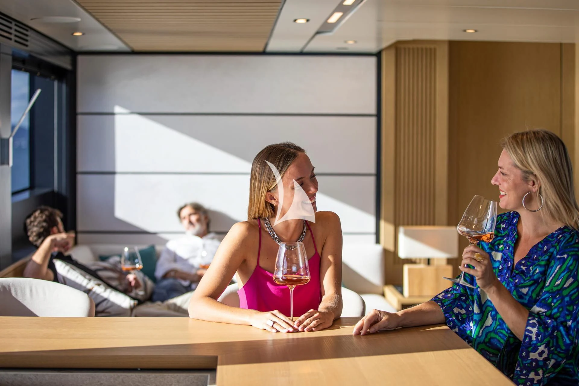 a group of women sitting at a table with wine glasses aboard WHY 200 Yacht for Sale