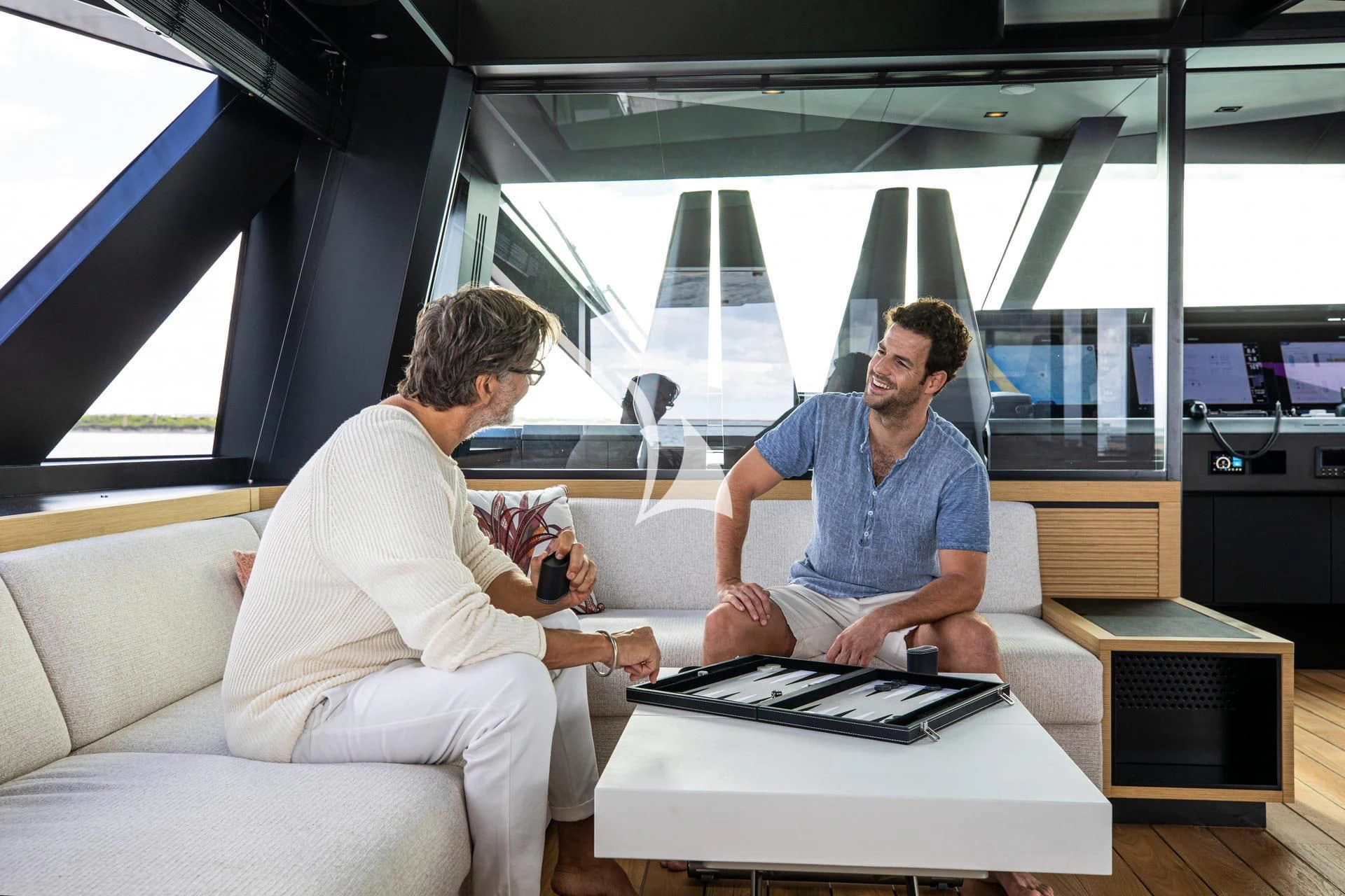 a few men sitting in a room aboard WHY 200 Yacht for Sale