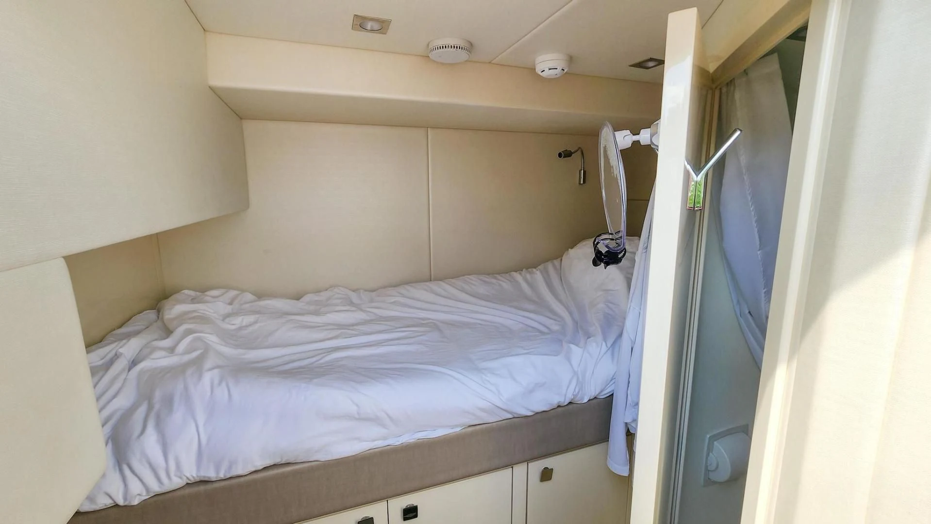 a bed with a white sheet aboard JOLLY ROGERS Yacht for Sale