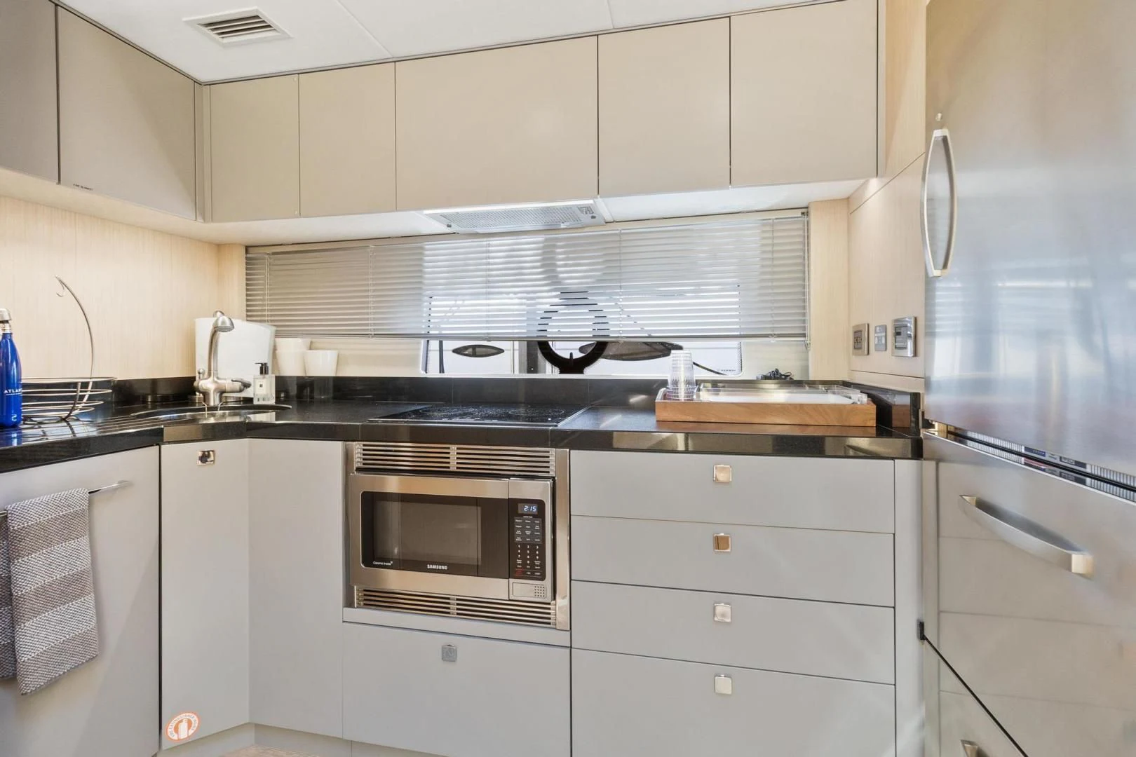 a kitchen with white cabinets aboard JOLLY ROGERS Yacht for Sale
