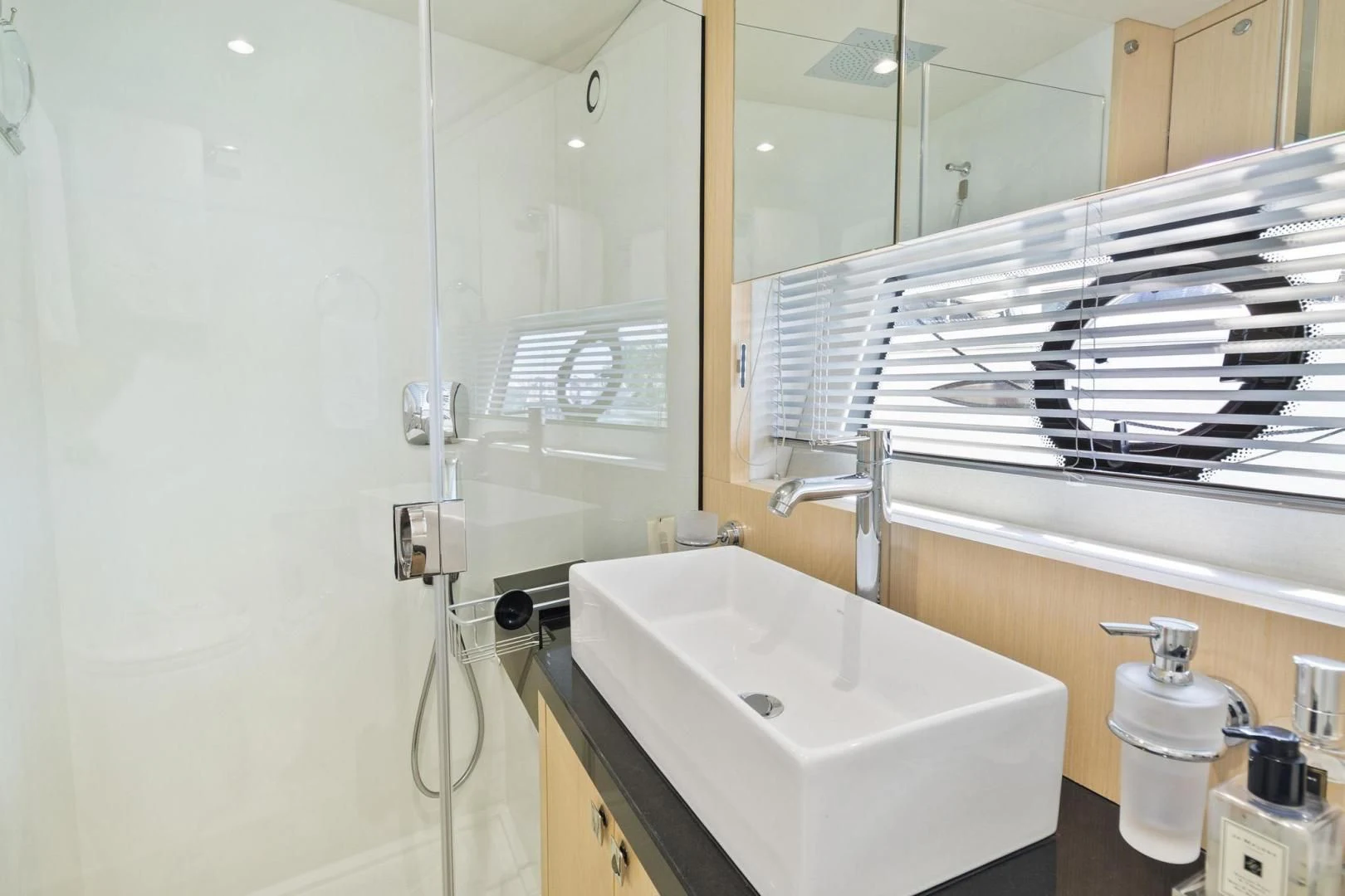 a bathroom with a sink and a mirror aboard JOLLY ROGERS Yacht for Sale