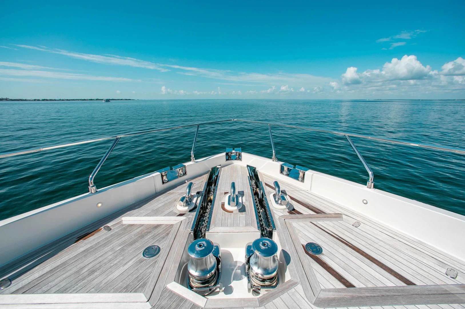 a deck with a large ship on it and a large body of water in the background aboard CRAZY Yacht for Sale