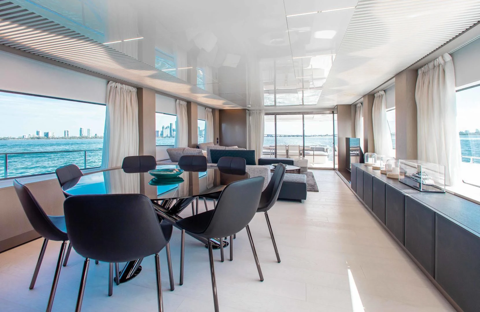 a room with tables and chairs aboard CRAZY Yacht for Sale