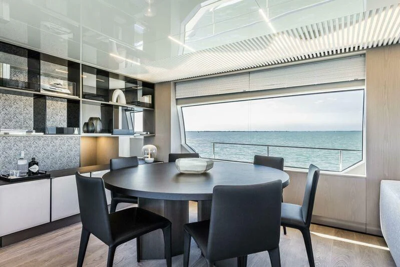 a dining table in a room aboard CRAZY Yacht for Sale