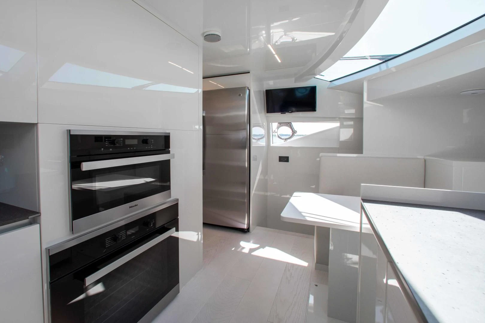 a kitchen with white cabinets aboard CRAZY Yacht for Sale